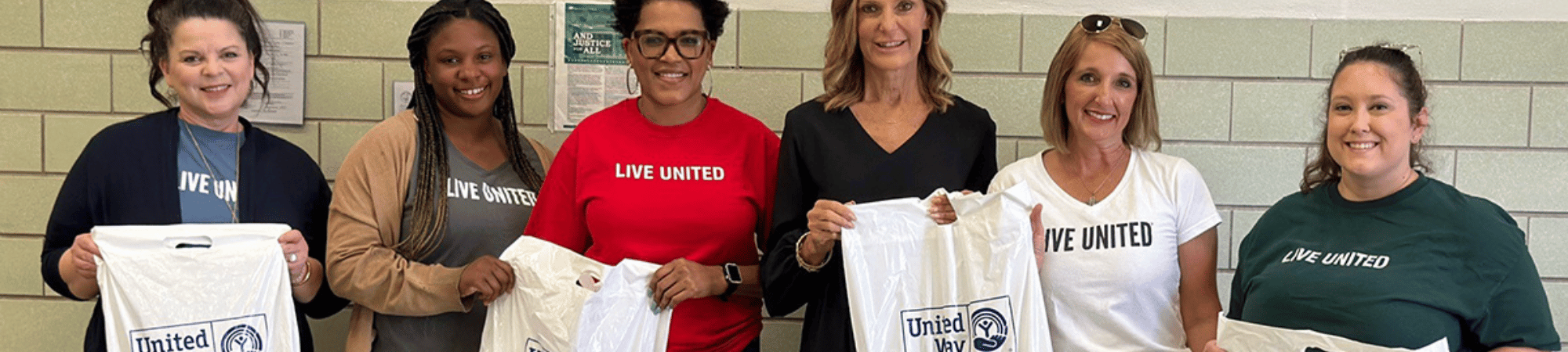 team members with bags of school supplies