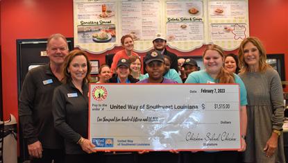 Chicken Salad Chick employees with big check